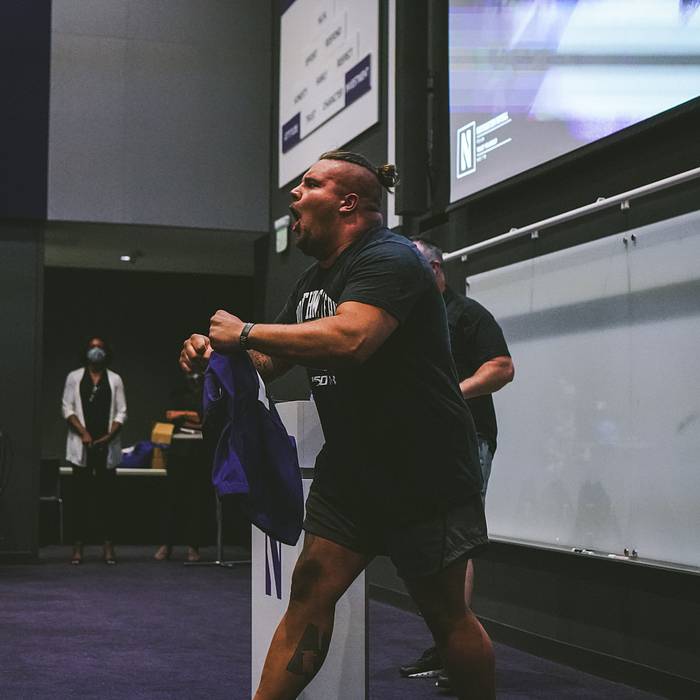 Defensive lineman Joe Spivak receives the No. 1 jersey from head coach Pat Fitzgerald.