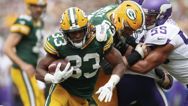 Green Bay Packers running back Aaron Jones (33) rushes for a touchdown during the second quarter against the Minnesota Vikings at Lambeau Field.