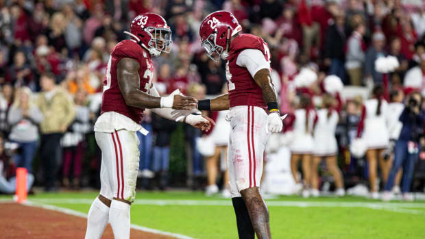 Anfernee Jennings and Terrell Lewis celebrate a sack against Tennessee