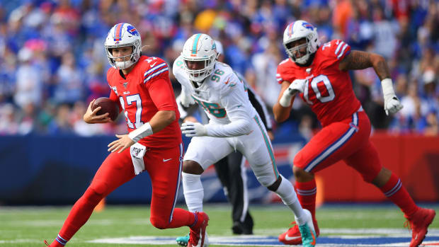 Oct 20, 2019; Orchard Park, NY, USA; Buffalo Bills quarterback Josh Allen (17) runs with the ball in front of Miami Dolphins defensive end Taco Charlton (96) during the first quarter at New Era Field. Mandatory Credit:
