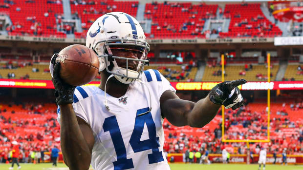 Indianapolis Colts wide receiver Zach Pascal (14) plays catch with fans in the stand before the game against the Kansas City Chiefs at Arrowhead Stadium.