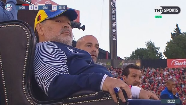 Diego Maradona coaches from a throne