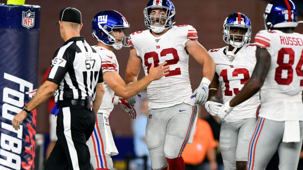 Aug 29, 2019; Foxborough, MA, USA; New York Giants tight end Scott Simonson (82) is held up by his teammates after injuring himself during a touchdown play against the New England Patriots during the second half at Gillette Stadium.