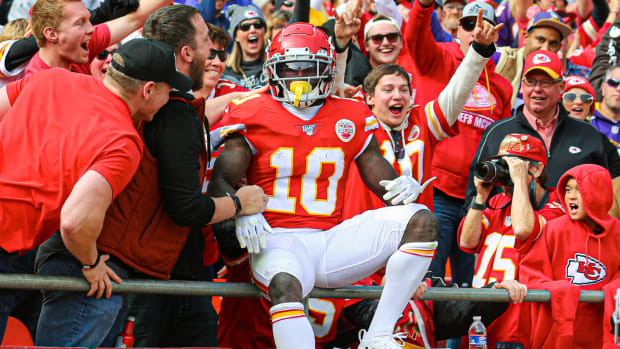 Tyreek Hill celebrates in stands with Chiefs fans.
