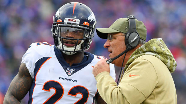 Denver Broncos head coach Vic Fangio talks with strong safety Kareem Jackson (22) during a time-out against the Buffalo Bills during the second quarter at New Era Field.