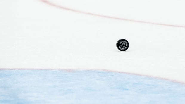 An NHL hockey puck rolling on the ice