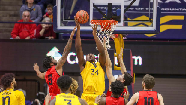 West Virginia Mountaineers forward Oscar Tshiebwe (34) shoots the ball over Austin Peay Governors guard Jordyn Adams (5) during the first half at WVU Coliseum.