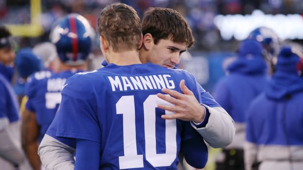 Dec 15, 2019; East Rutherford, NJ, USA; New York Giants injured quarterback Daniel Jones (8) hugs quarterback Eli Manning (10) during the fourth quarter against the Miami Dolphins at MetLife Stadium.