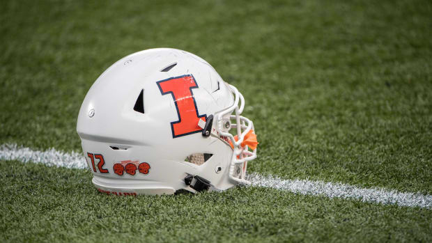 An Illinois Fighting Illini helmet sits on the grass during pre game before a game against the Minnesota Golden Gophers at TCF Bank Stadium.