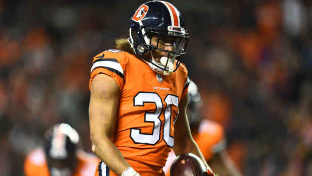 Denver Broncos running back Phillip Lindsay (30) celebrates his touchdown carry in the fourth quarter against the Pittsburgh Steelers at Broncos Stadium at Mile High.