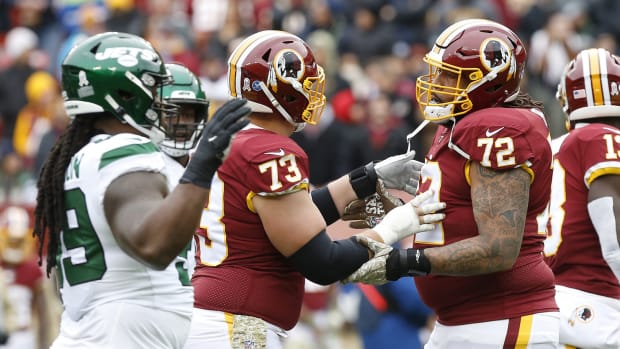 Washington Redskins offensive tackle Donald Penn (72) is restrained by Redskins center Chase Roullier (73) after arguing with an official against the New York Jets in the second quarter at FedExField.