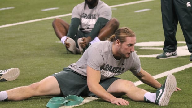 Riley Bullough warms up prior to the 2015 B1G Championship game.
