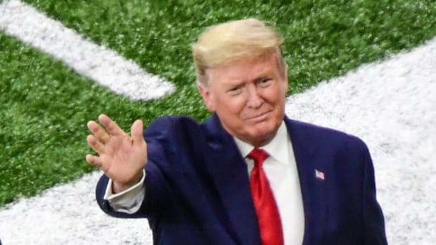President Donald Trump on the field of the College Football Playoff final