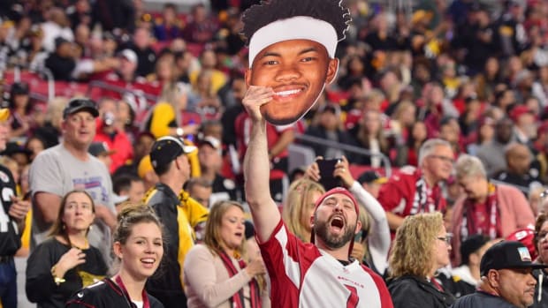 A fan holds a Arizona Cardinals quarterback Kyler Murray (1) sign prior to the game against the Pittsburgh Steelers at State Farm Stadium.