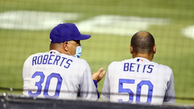 Jul 30, 2020; Phoenix, Arizona, USA; Los Angeles Dodgers manager Dave Roberts (left) with outfielder Mookie Betts against the Arizona Diamondbacks during the home opener at Chase Field. Mandatory Credit: Mark J. Rebilas-USA TODAY Sports