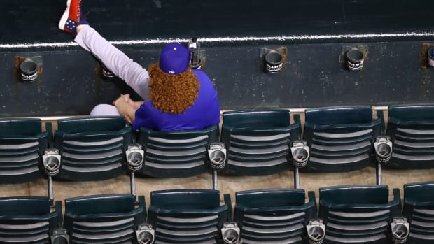 Jul 31, 2020; Phoenix, Arizona, USA; Los Angeles Dodgers pitcher Dustin May watches from the front row seats in the grandstands in the fourth inning against the Arizona Diamondbacks at Chase Field. Mandatory Credit: Mark J. Rebilas-USA TODAY Sports