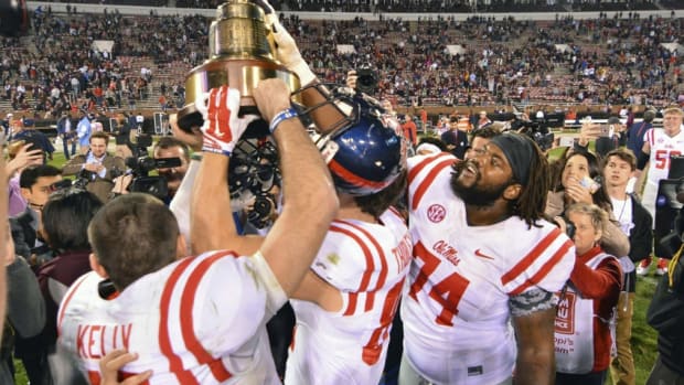 Mississippi Rebels players celebrate with the Egg Bowl trophy after the game against the Mississippi State Bulldogs at Davis Wade Stadium. Mississippi won 38-27. Mandatory Credit: Matt Bush-USA TODAY Sports