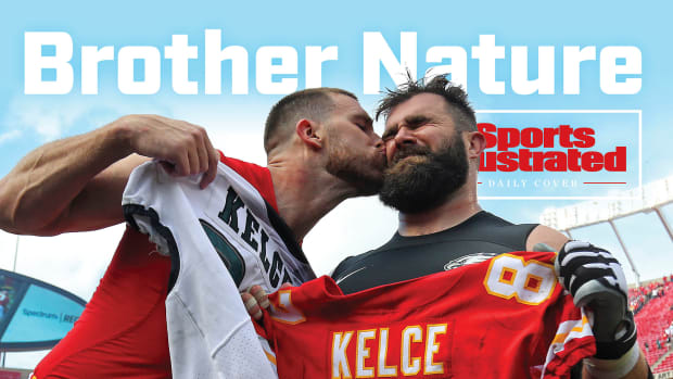 Travis Kelce gives brother Jason a post-game kiss on the cheek as they exchange jerseys