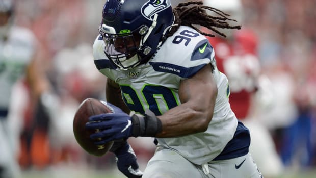 Seattle Seahawks outside linebacker Jadeveon Clowney (90) returns an interception for a touchdown against the Arizona Cardinals during the first half at State Farm Stadium.