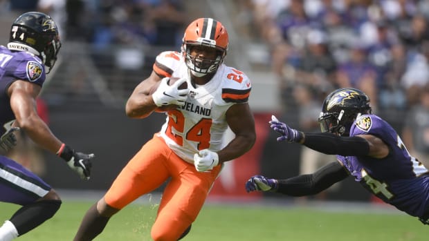 Sep 29, 2019; Baltimore, MD, USA; Cleveland Browns running back Nick Chubb (24) carries the ball as Baltimore Ravens cornerback Brandon Carr (24) defends in the first quarter in a football game against the Cleveland Browns at M&T Bank Stadium. Mandatory Credit: Mitchell Layton-USA TODAY Sports