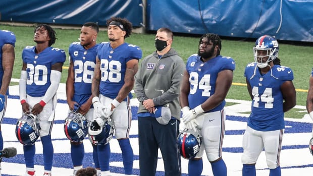Sep 14, 2020; East Rutherford, New Jersey, USA; New York Giants head coach Joe Judge stands for a pregame ceremony with cornerback Darnay Holmes (30) and running back Saquon Barkley (26) and tight end Evan Engram (88) and defensive end Dalvin Tomlinson (94) and linebacker Markus Golden (44) before their game against the Pittsburgh Steelers at MetLife Stadium.
