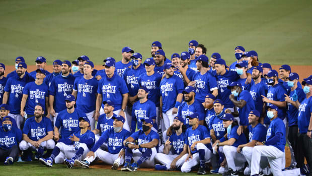 Sep 22, 2020; Los Angeles, California, USA; Los Angeles Dodgers pose for a group photo following the 7-2 victory against the Oakland Athletics and clinching of the National League West division at Dodger Stadium. Mandatory Credit: Gary A. Vasquez-USA TODAY Sports