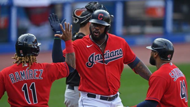 Sep 27, 2020; Cleveland, Ohio, USA; Cleveland Indians designated hitter Franmil Reyes (32) celebrates with third basemen Jose Ramirez (11) and first basemen Carlos Santana (41) after hitting a three-run home run during the sixth inning against the Pittsburgh Pirates at Progressive Field.