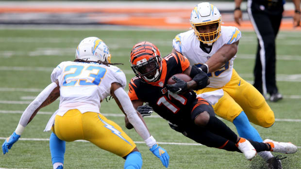 Cincinnati Bengals wide receiver John Ross (11) goes down after making a reception in the first quarter during a Week 1 NFL football game against the Los Angeles Chargers, Sunday, Sept. 13, 2020, at Paul Brown Stadium in Cincinnati. Los Angeles Chargers At Cincinnati Bengals Sept 13