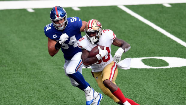 San Francisco 49ers running back Jeff Wilson (30) rushes with pressure from New York Giants linebacker Blake Martinez (54). The New York Giants lose to the San Francisco 49ers, 36-9, in an NFL game at MetLife Stadium on Sunday, Sept. 27, 2020, in East Rutherford. Giants 49ers