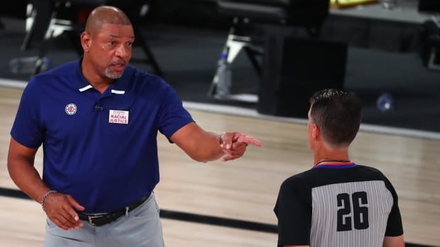 Former Los Angeles Clippers coach Doc Rivers talks with referee Pat Fraher during a game against the Denver Nuggets in the second round of the 2020 NBA Playoffs at AdventHealth Arena.