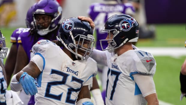 Sep 27, 2020;  Minneapolis, Minnesota, United States;  Tennessee Titans quarterback Ryan Tannehill (17) congratulates running back Derrick Henry (22) after his third quarter touchdown against the Minnesota Vikings at US Bank Stadium.  Mandatory Credit: Brad Rempel-USA TODAY Sports