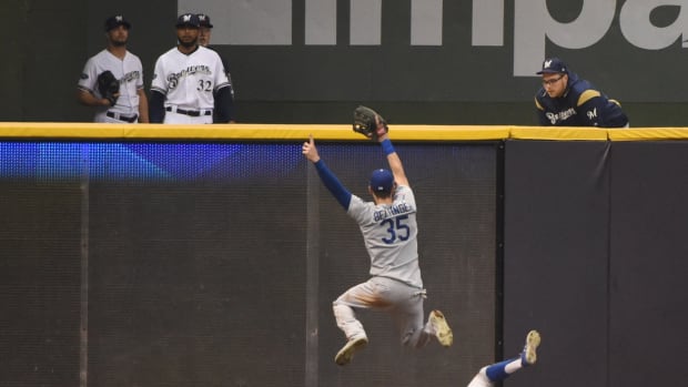 Oct 20, 2018; Milwaukee, WI, USA; Los Angeles Dodgers outfielder Chris Taylor (3) slides and avoids teammate Cody Bellinger (35) to make a catch on a ball hit by Milwaukee Brewers outfielder Christian Yelich (not pictured) in the fifth inning in game seven of the 2018 NLCS playoff baseball series at Miller Park. Mandatory Credit: Benny Sieu-USA TODAY Sports