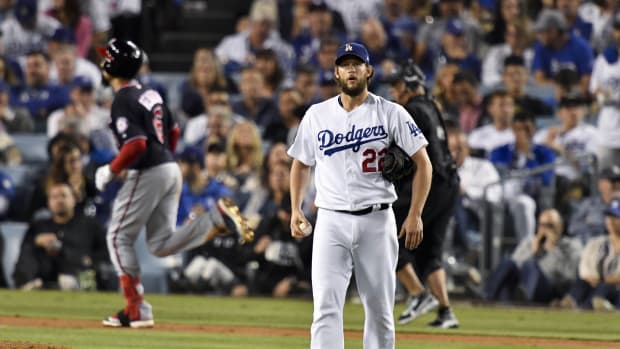 Oct 9, 2019; Los Angeles, CA, USA; Los Angeles Dodgers starting pitcher Clayton Kershaw (22) reacts after allowing a solo home run to Washington Nationals third baseman Anthony Rendon (6) during the seventh inning in game five of the 2019 NLDS playoff baseball series at Dodger Stadium. Mandatory Credit: Robert Hanashiro-USA TODAY Sports