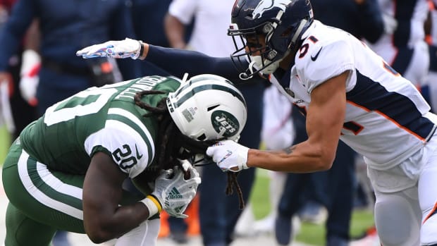 Denver Broncos safety Justin Simmons (31) grabs New York Jets running back Isaiah Crowell (20) hair in the second half at MetLife Stadium.