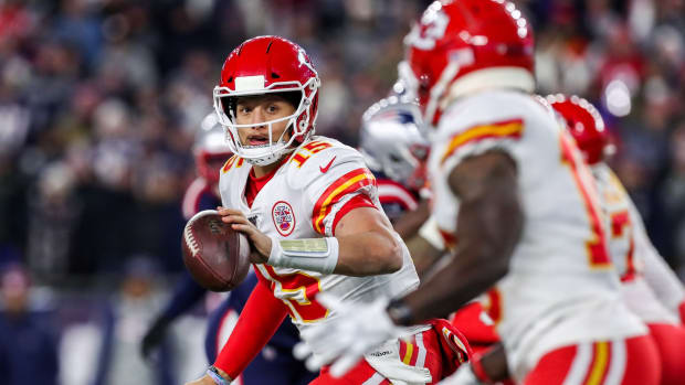 Dec 8, 2019; Foxborough, MA, USA; Kansas City Chiefs quarterback Patrick Mahomes (15) flips the ball to Kansas City Chiefs receiver Tyreek Hill (10) during the second half against the New England Patriots at Gillette Stadium. Mandatory Credit: Paul Rutherford-USA TODAY Sports