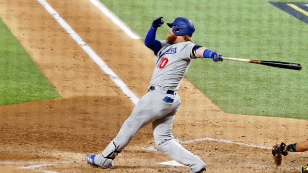 Oct 8, 2020; Arlington, Texas, USA; Los Angeles Dodgers third baseman Justin Turner (10) hits an RBI single against the San Diego Padres during the third inning during game three of the 2020 NLDS at Globe Life Field. Mandatory Credit: Kevin Jairaj-USA TODAY Sports