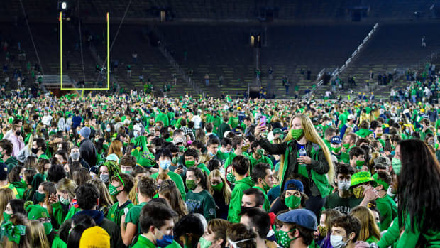 Fans storm the field after the Notre Dame Fighting Irish defeated the Clemson Tigers 47-40 in two overtimes.