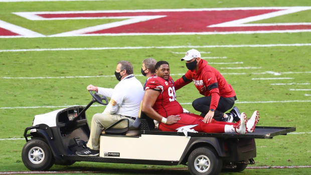 Arizona Cardinals defensive tackle Corey Peters (98) reacts as he is charted off the field after suffering an injury against the Buffalo Bills at State Farm Stadium.