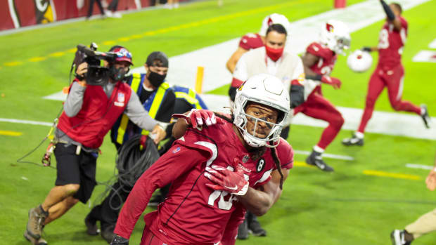 Arizona Cardinals wide receiver DeAndre Hopkins (10) celebrates with teammates after catching a Hail Mary pass for a touchdown in the closing seconds of the game against the Buffalo Bills at State Farm Stadium.