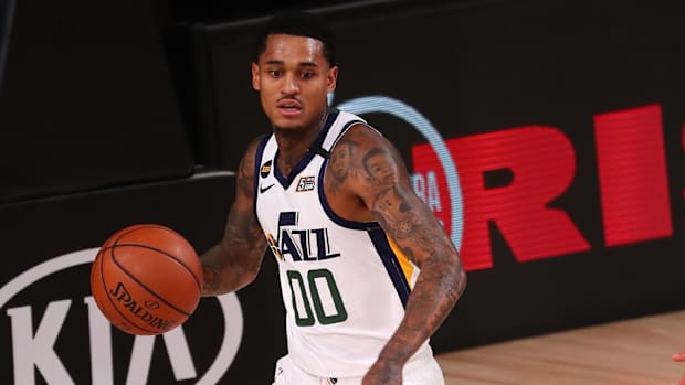 Utah Jazz guard Jordan Clarkson (00) brings the ball up court against Denver Nuggets center Nikola Jokic (15) during the first half of game seven of the first round of the 2020 NBA Playoffs