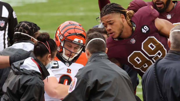 Nov 22, 2020; Landover, Maryland, USA; Cincinnati Bengals quarterback Joe Burrow (9) shakes hands with Washington Football Team defensive end Chase Young (99) prior to being carted off the field after injuring his left knee in the third quarter at FedExField.