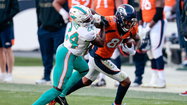 Denver Broncos wide receiver Tim Patrick (81) runs the ball on a reception as Miami Dolphins cornerback Byron Jones (24) defends in the second quarter at Empower Field at Mile High.