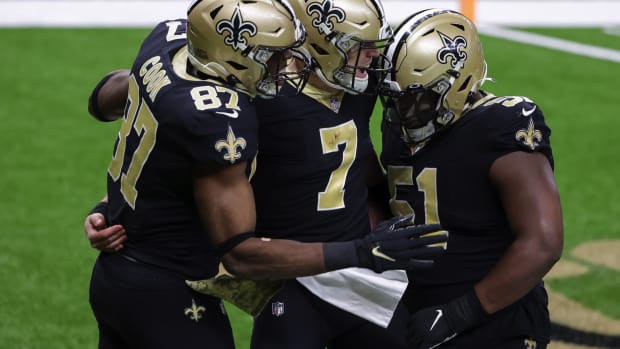 New Orleans Saints quarterback Taysom Hill (7) celebrates with center Cesar Ruiz (51) and tight end Jared Cook (87) after a touchdown against the Atlanta Falcons during the second half at the Mercedes-Benz Superdome.