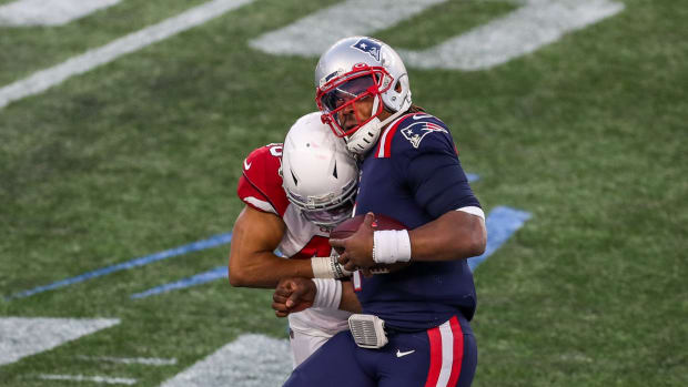 New England Patriots quarterback Cam Newton (1) is tackled by Arizona Cardinals linebacker Isaiah Simmons (48) during the second half at Gillette Stadium.