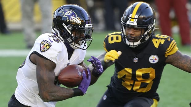 Dec 2, 2020; Pittsburgh, Pennsylvania, USA; Baltimore Ravens running back Gus Edwards (35) carries the ball against Pittsburgh Steelers outside linebacker Bud Dupree (48) during the first quarter at Heinz Field.