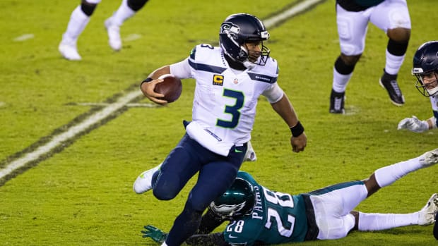 Nov 30, 2020; Philadelphia, Pennsylvania, USA; Seattle Seahawks quarterback Russell Wilson (3) eludes the tackle attempt of Philadelphia Eagles strong safety Will Parks (28) during the fourth quarter at Lincoln Financial Field.