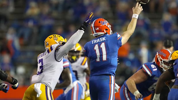 Florida Gators quarterback Kyle Trask (11) throws the ball as LSU defender Andre Gilbert (3) pressures during a game against the LSU Tigers