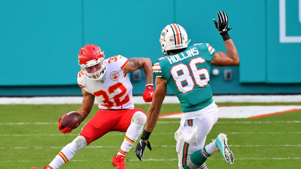 Dec 13, 2020; Miami Gardens, Florida, USA; Kansas City Chiefs strong safety Tyrann Mathieu (32) runs the ball past Miami Dolphins wide receiver Mack Hollins (86) after intercepting a pass from Miami Dolphins quarterback Tua Tagovailoa (1, not pictured) during the first half at Hard Rock Stadium. Mandatory Credit: Jasen Vinlove-USA TODAY Sports