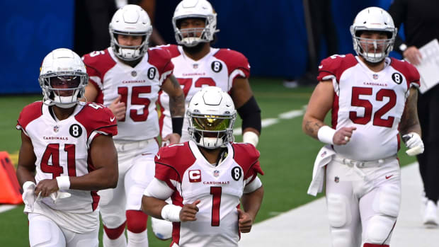 Arizona Cardinals quarterback Kyler Murray (1) leads a group of Cardinals players onto the field for pregame warmups before the game against the Los Angeles Rams at SoFi Stadium.