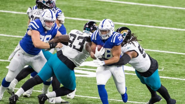 Running back Jonathan Taylor bursts through an opening as part of a 253-yard, two-TD effort in the Indianapolis Colts' Sunday home win over the Jacksonville Jaguars.